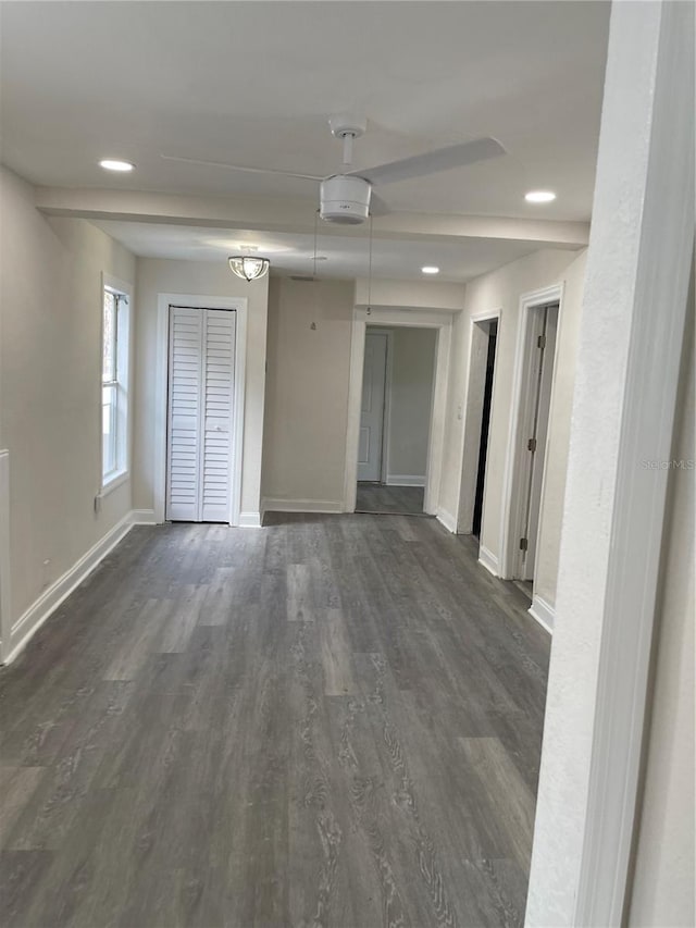 unfurnished room with dark wood-type flooring