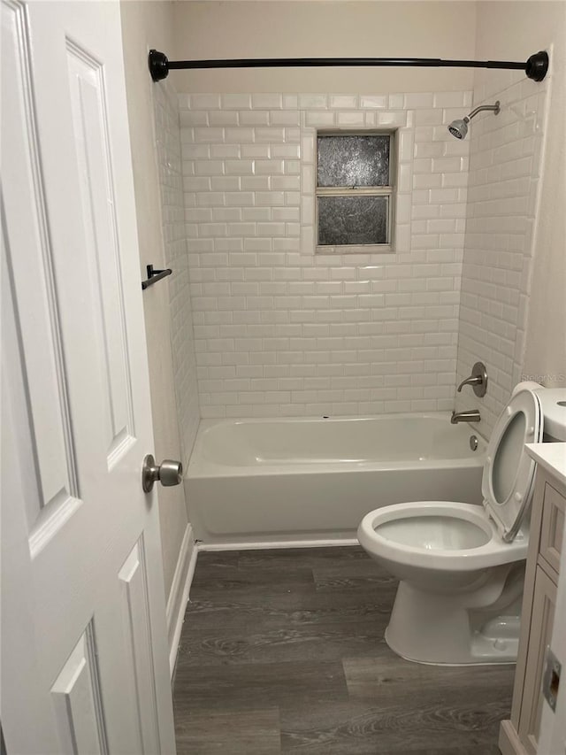 full bathroom featuring toilet, vanity, tiled shower / bath, and hardwood / wood-style flooring