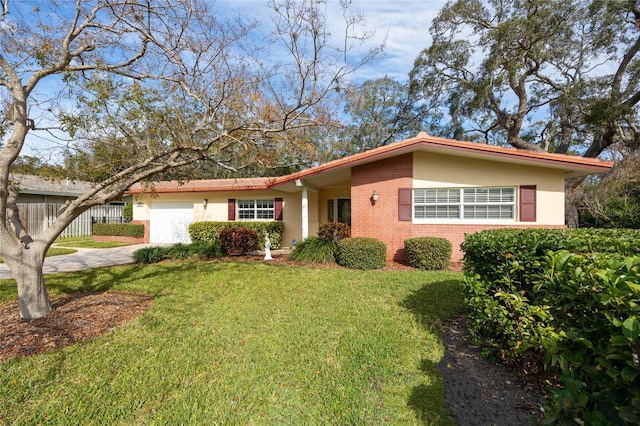 single story home with a garage and a front yard