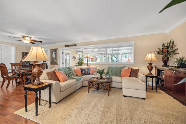 living room featuring crown molding, light wood-type flooring, a wall mounted air conditioner, and ceiling fan