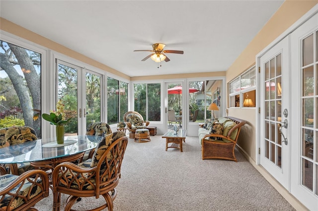 sunroom featuring ceiling fan and french doors