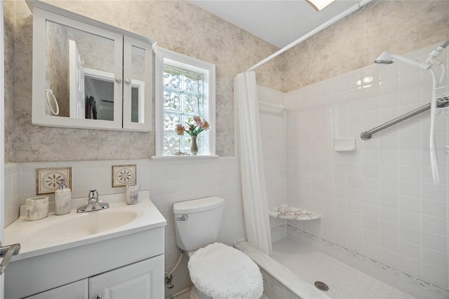 bathroom featuring toilet, vanity, and a shower with curtain