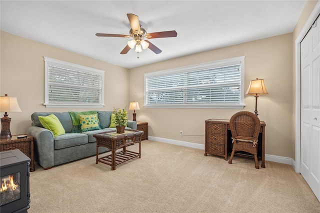 sitting room with ceiling fan and light carpet