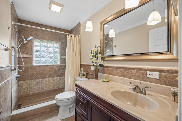 bathroom with toilet, tile walls, ornamental molding, a shower with shower curtain, and vanity