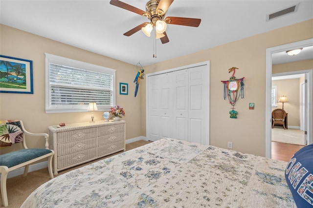 bedroom featuring ceiling fan, a closet, and carpet floors