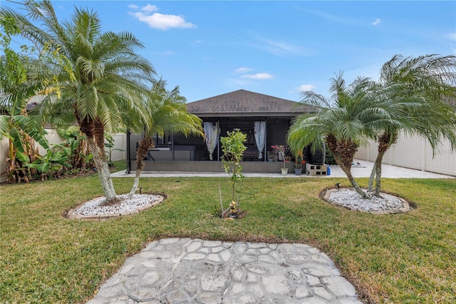 view of front of house with a front lawn and a sunroom