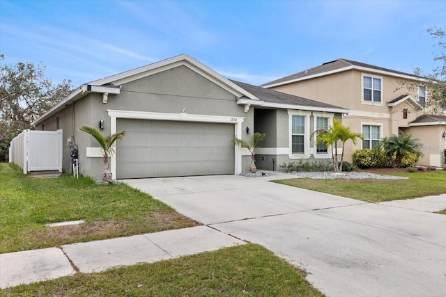 ranch-style home featuring a garage and a front yard