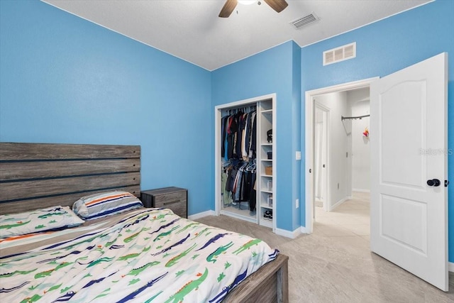 carpeted bedroom with ceiling fan and a closet