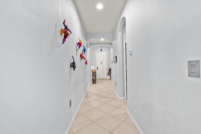 hall featuring light tile patterned flooring