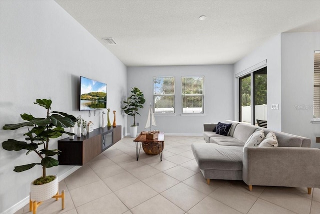 tiled living room with a textured ceiling