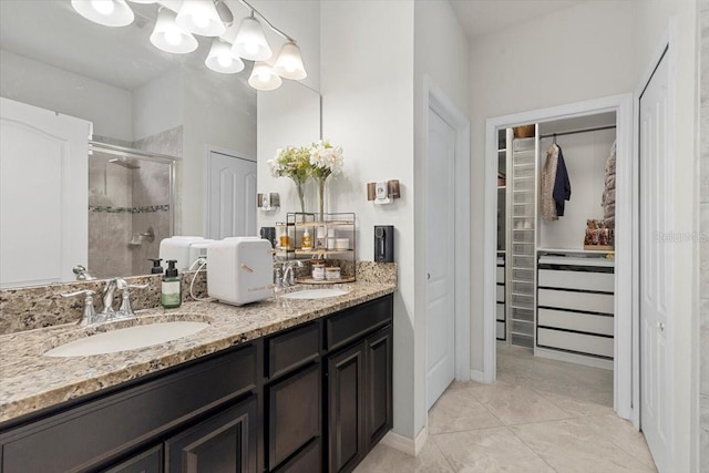 bathroom featuring walk in shower, vanity, and tile patterned flooring