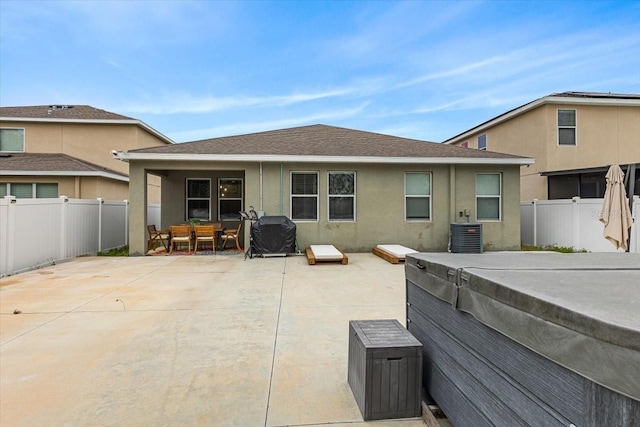 rear view of house featuring central AC and a patio