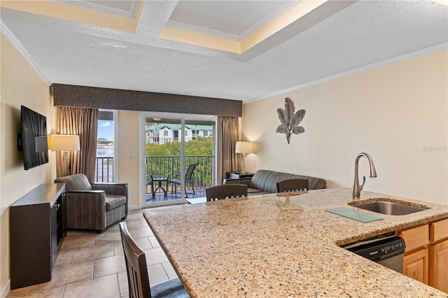 2506 N Rocky Point Dr Unit 272, Tampa, FL 33607 - kitchen with a sink, open floor plan, ornamental molding, light stone counters, and a breakfast bar area