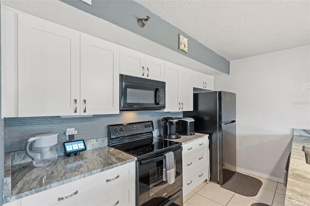 kitchen featuring tasteful backsplash, black appliances, white cabinetry, light tile patterned floors, and light stone counters