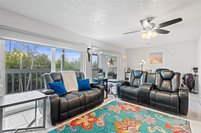 tiled living room with ceiling fan and a textured ceiling