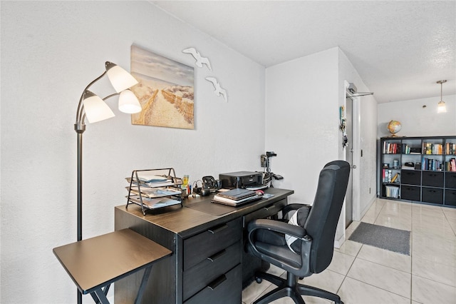 office space featuring a textured ceiling and light tile patterned floors