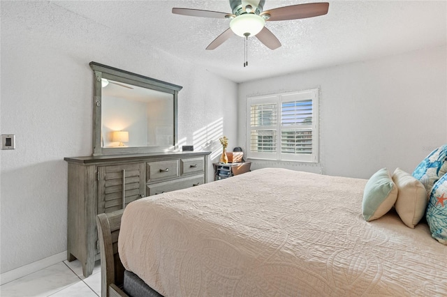 bedroom with ceiling fan, a textured ceiling, and light tile patterned flooring