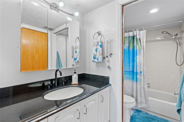 full bathroom featuring toilet, vanity, shower / tub combo, and a textured ceiling