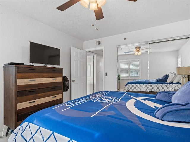 bedroom featuring ceiling fan, a textured ceiling, and a closet