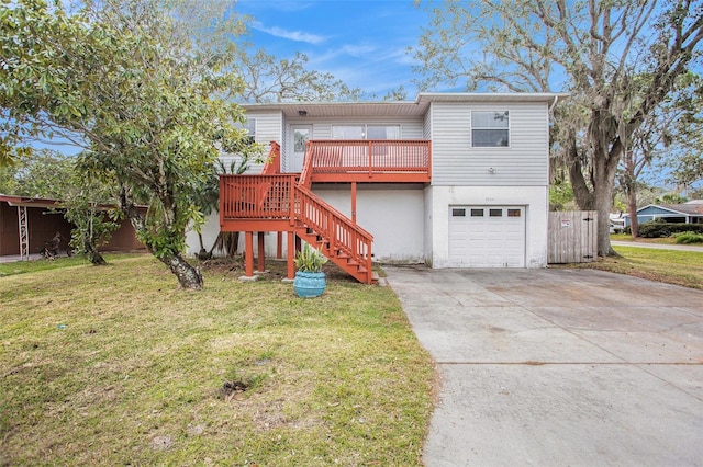 view of front facade with a front yard, a deck, and a garage