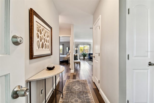 corridor with dark hardwood / wood-style floors