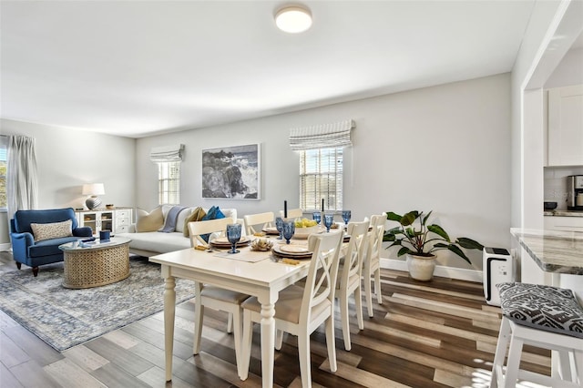 dining space with hardwood / wood-style flooring and plenty of natural light