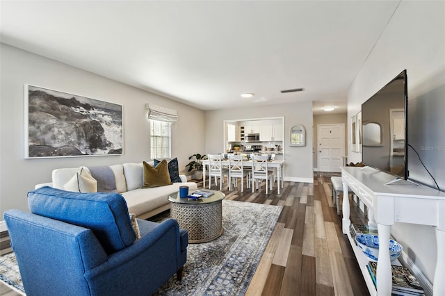 living room with dark hardwood / wood-style flooring