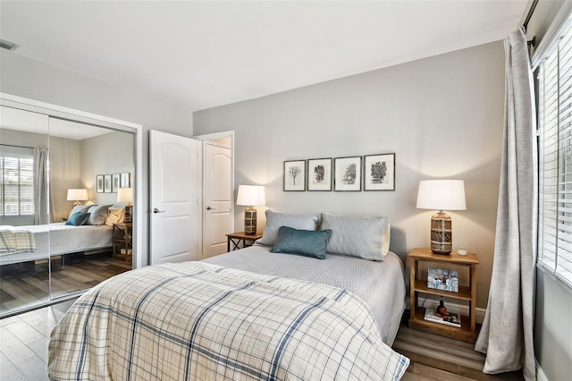 bedroom with wood-type flooring and a closet