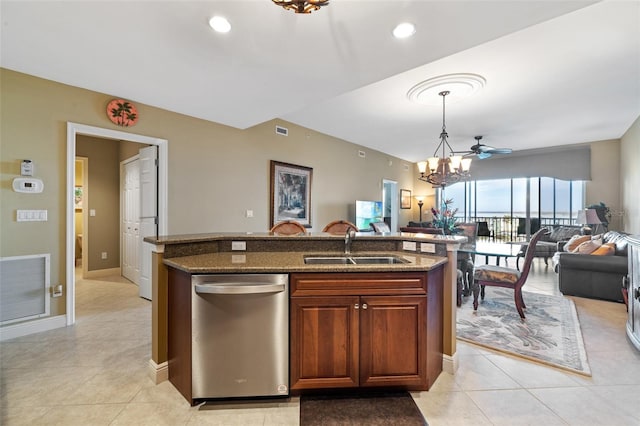 kitchen with sink, dark stone countertops, hanging light fixtures, stainless steel dishwasher, and a notable chandelier