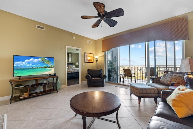 tiled living room featuring ceiling fan