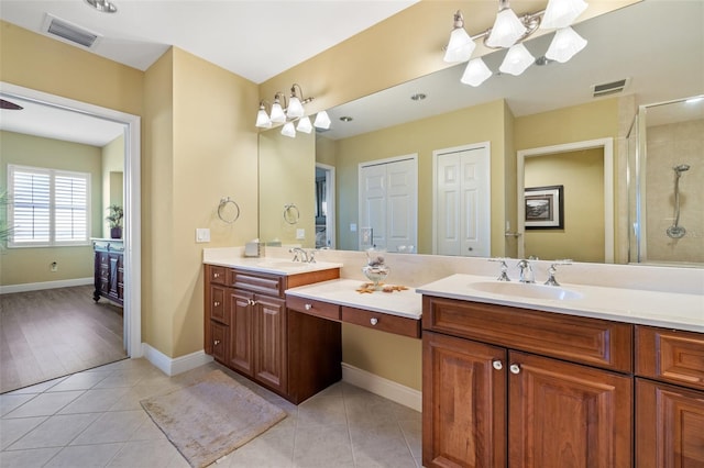 bathroom with tile patterned floors, vanity, and an enclosed shower