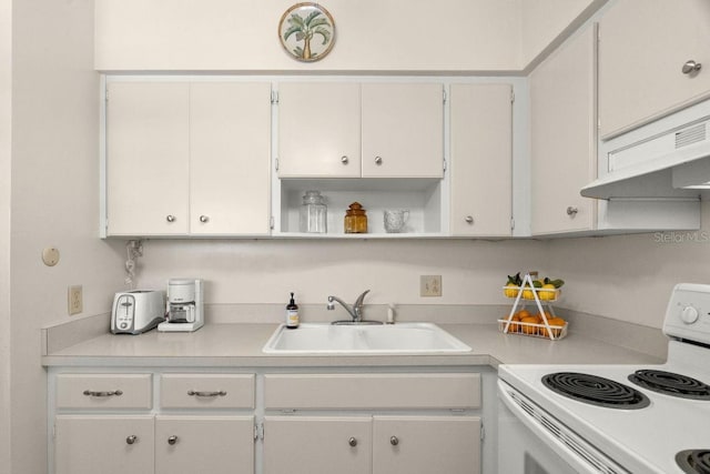 kitchen featuring sink, white cabinets, and electric range