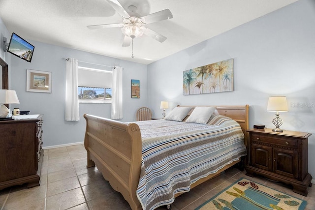 tiled bedroom featuring ceiling fan