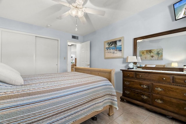 tiled bedroom with a closet and ceiling fan