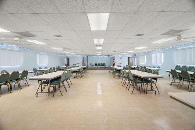 dining space featuring a paneled ceiling, ceiling fan, and plenty of natural light