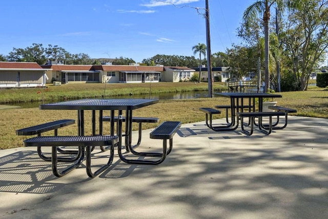 view of property's community with a water view and a yard