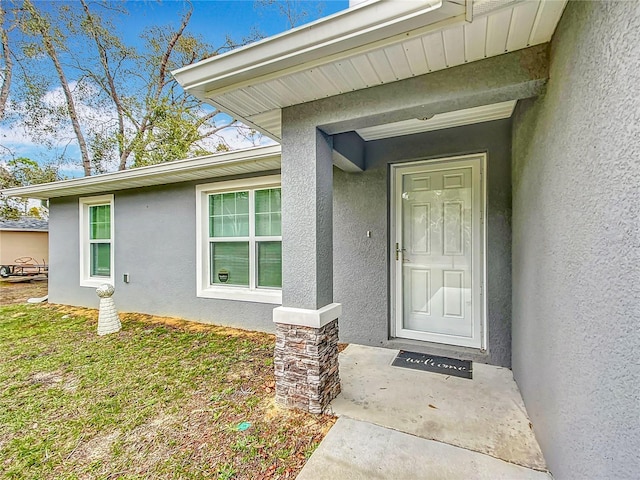 property entrance with a yard