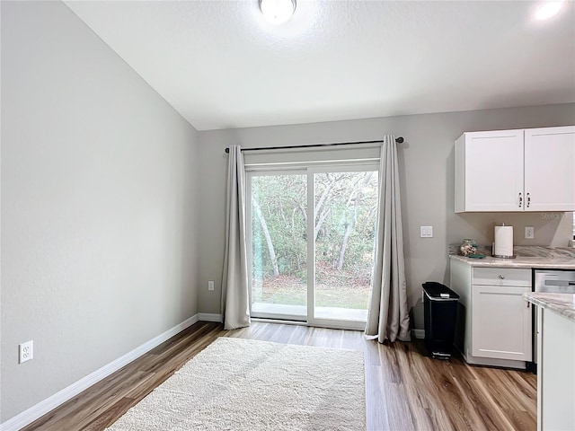 interior space featuring vaulted ceiling and hardwood / wood-style floors