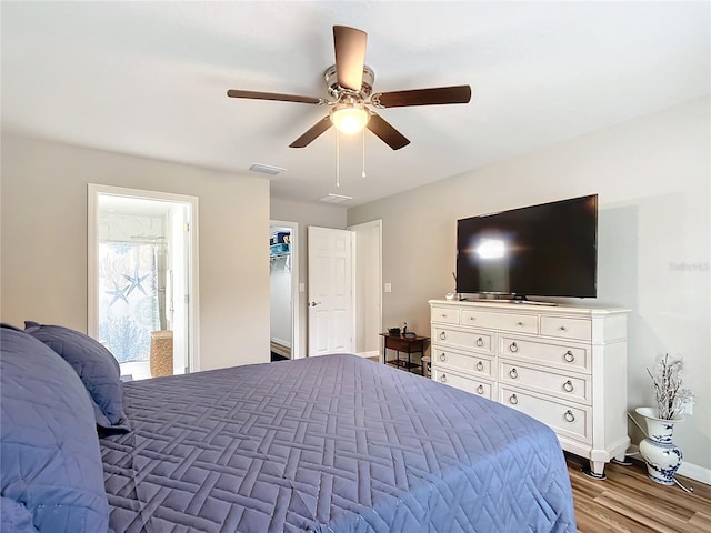 bedroom featuring light hardwood / wood-style floors, ensuite bath, and ceiling fan