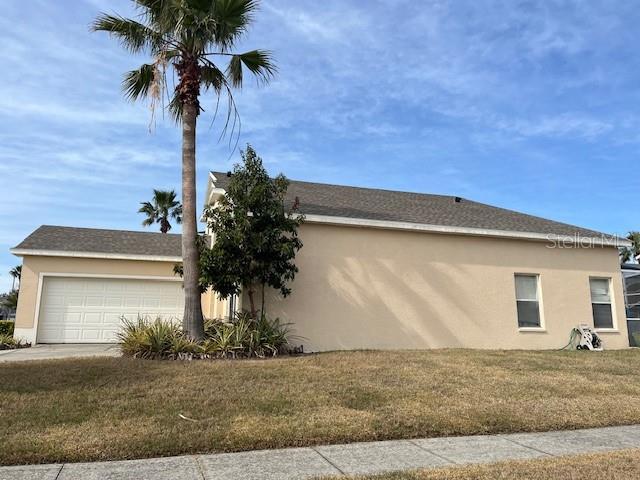 view of property exterior featuring a lawn and a garage