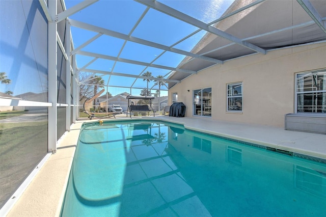 view of pool featuring a patio and glass enclosure