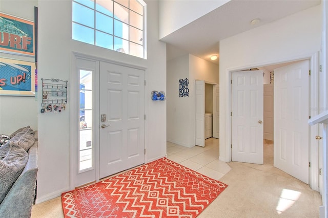 foyer entrance with a high ceiling and carpet