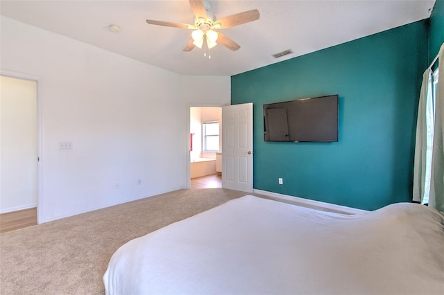 bedroom featuring light carpet and ceiling fan