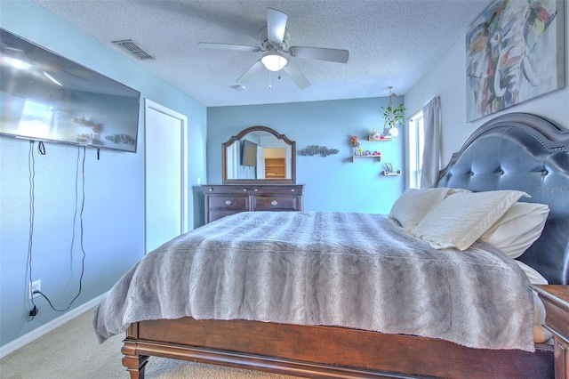 bedroom featuring ceiling fan, carpet, and a textured ceiling