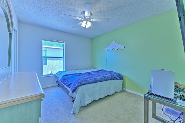 bedroom with ceiling fan, light carpet, and a textured ceiling