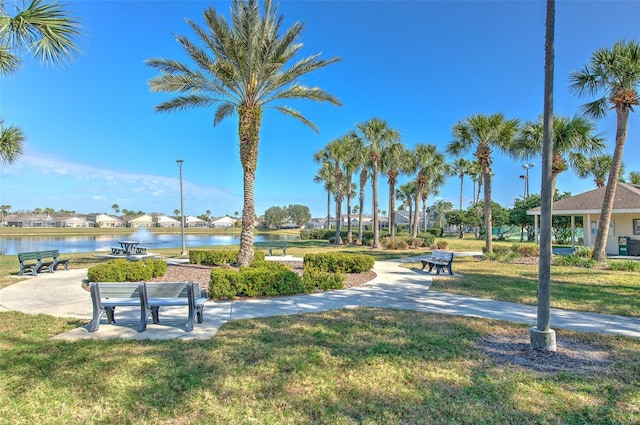 view of home's community featuring a water view and a yard