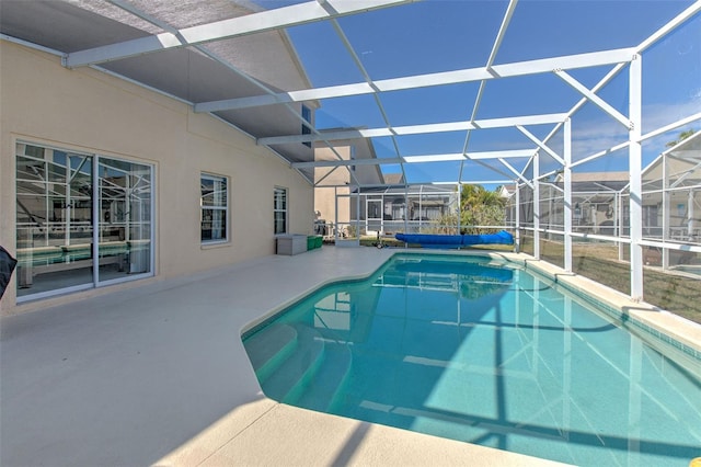 view of swimming pool with a lanai and a patio area