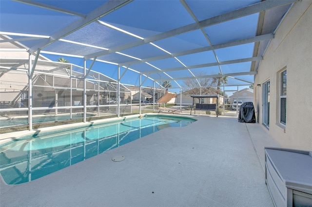 view of pool featuring a patio area and glass enclosure