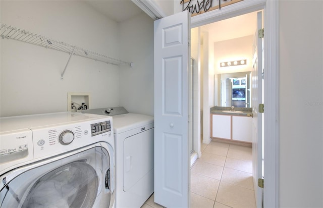 laundry room with separate washer and dryer and light tile patterned floors