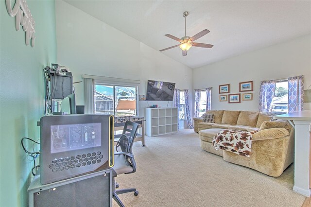 home office with ceiling fan, carpet flooring, high vaulted ceiling, and a wealth of natural light